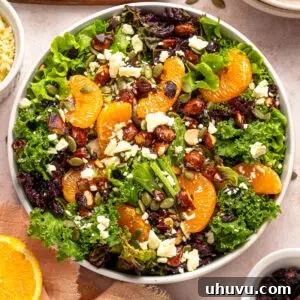 Assembling a fresh citrus salad with mixed greens and toppings