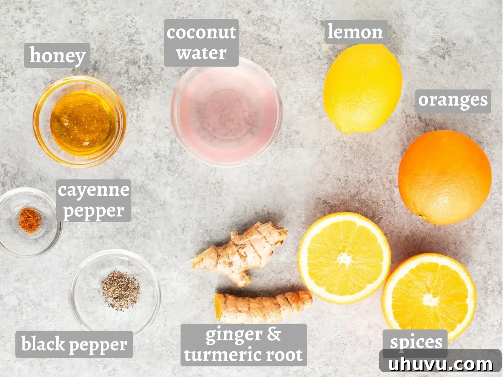 Ingredients for ginger turmeric shots including ginger, turmeric, citrus, honey, coconut water, and spices