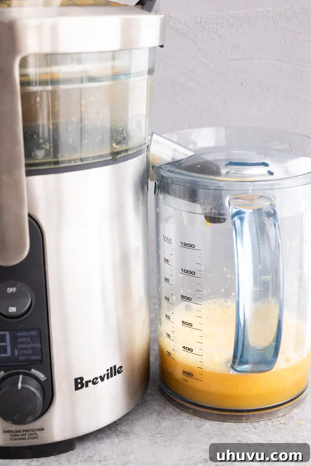 Juicing ginger, turmeric, orange, and lemon for homemade wellness shots