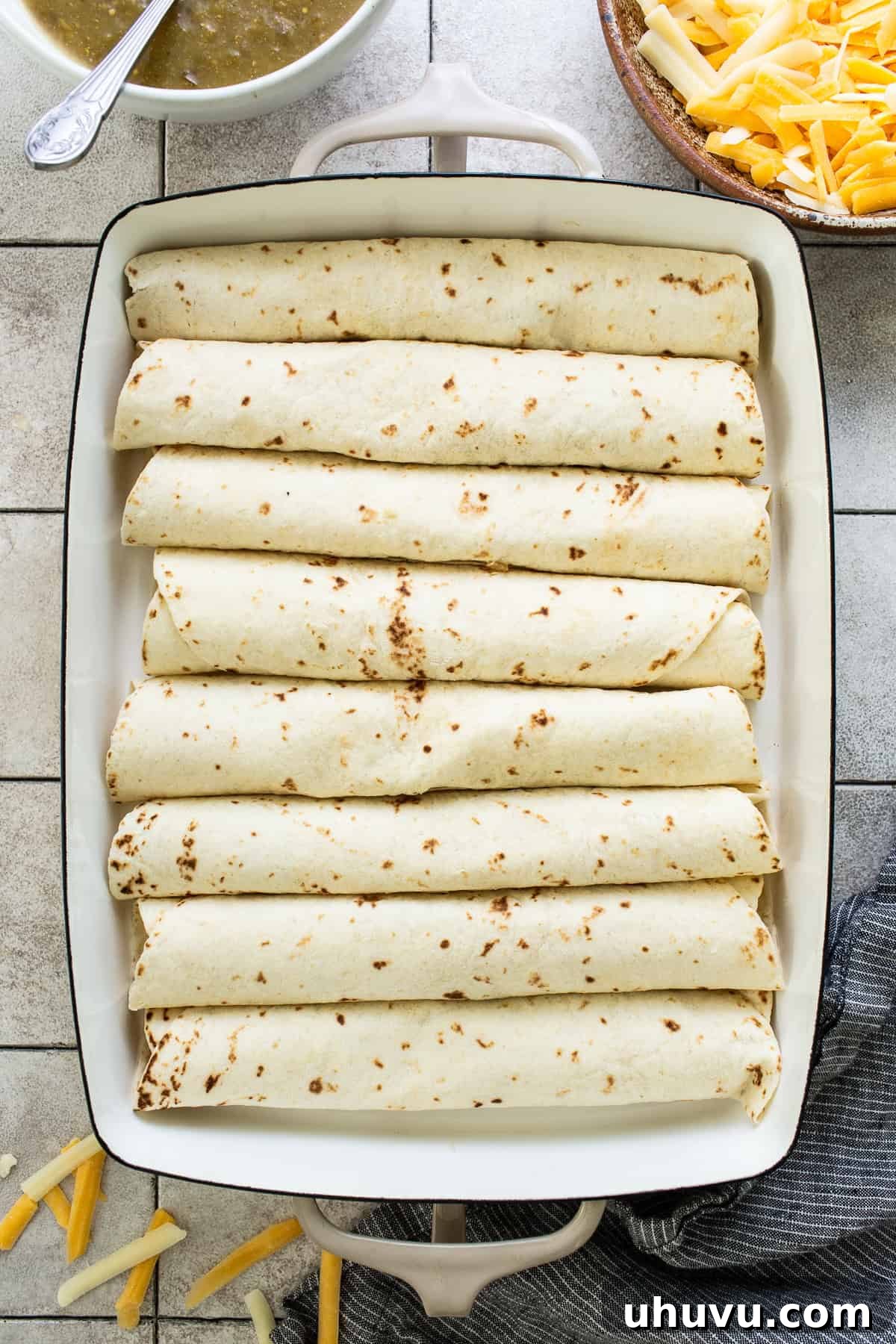 Creamy Spinach Enchiladas 5 Warm flour tortillas, filled with the creamy spinach and mushroom mixture, rolled and neatly arranged in a baking dish.
