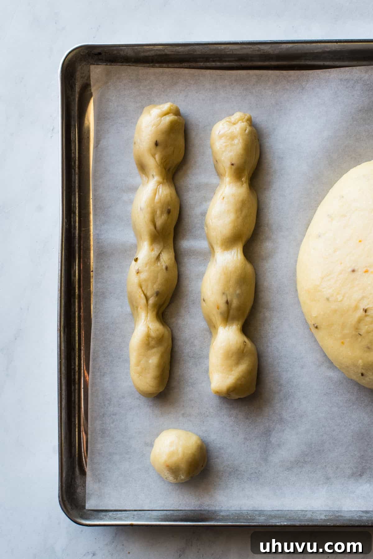 Spirits' Sweet Bread 5 Rolled out dough and "bones" shaped for pan de muerto before being assembled on a baking sheet.