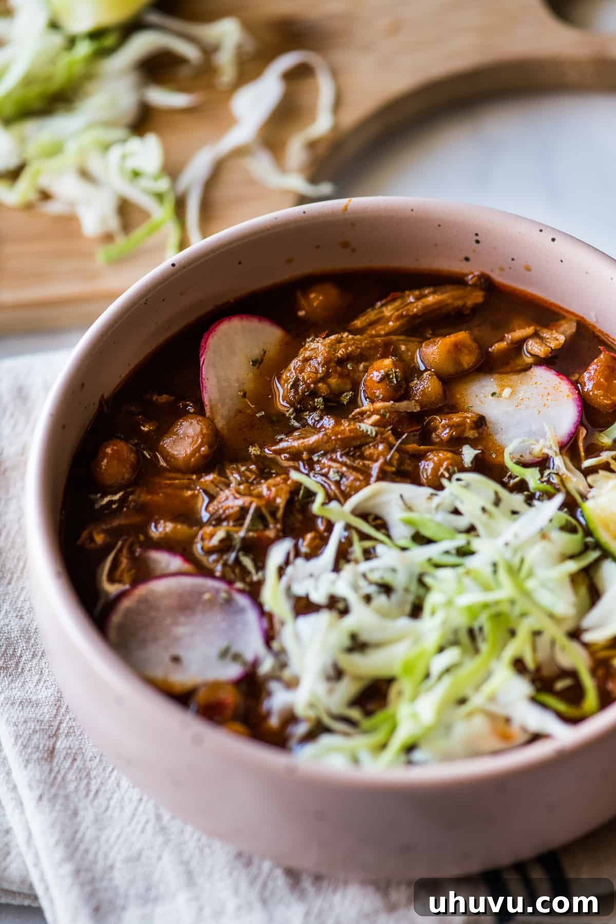 Instant Pot Pozole made with shredded pork and hominy in a red chile sauce.
