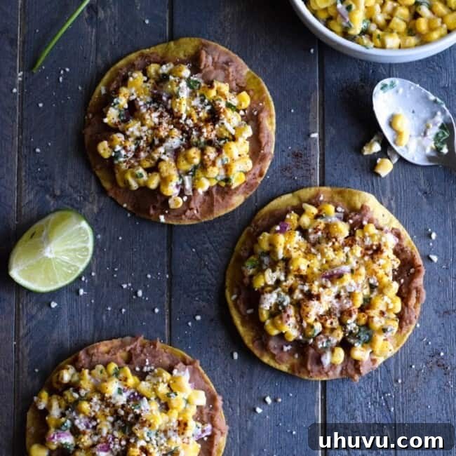 A visually appealing Mexican Street Corn Tostada, garnished with fresh cilantro, ready to be served. This image represents the quick, easy, gluten-free, and vegetarian attributes of the recipe, inviting viewers to savor its authentic flavors.
