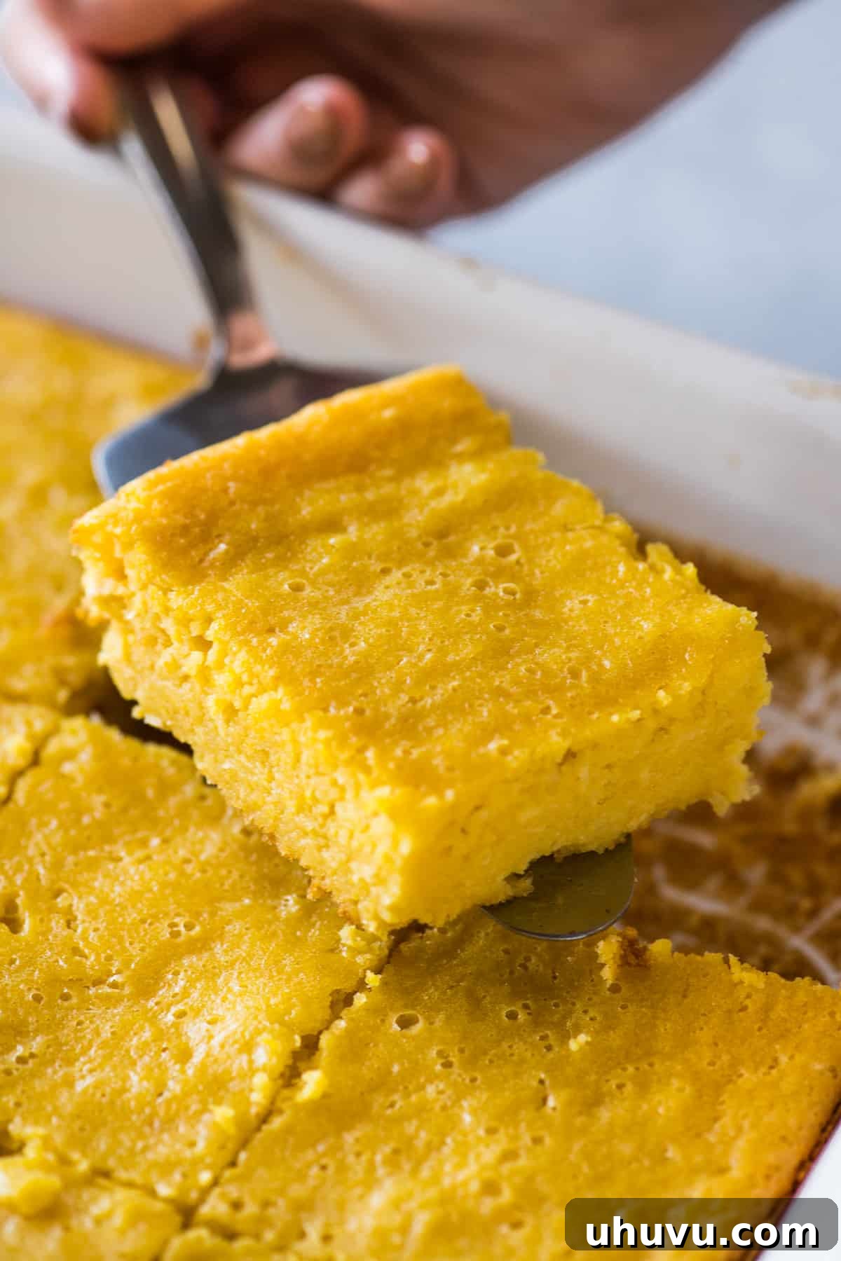 Golden Sweet Corn Cake 6 A slice of pan de elote on a cake server.