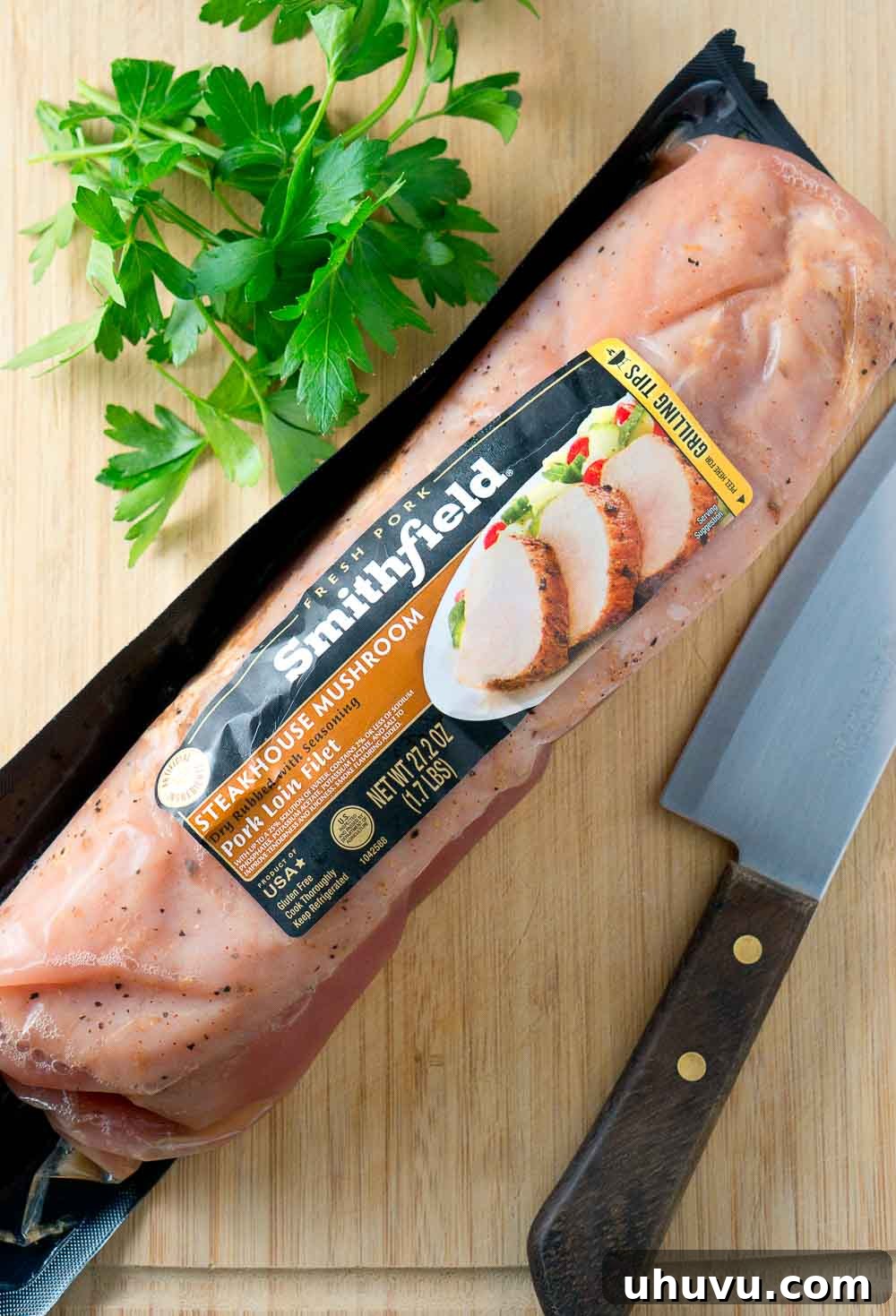 A serving of pork medallions with creamy mushroom Marsala sauce, garnished with fresh parsley.
