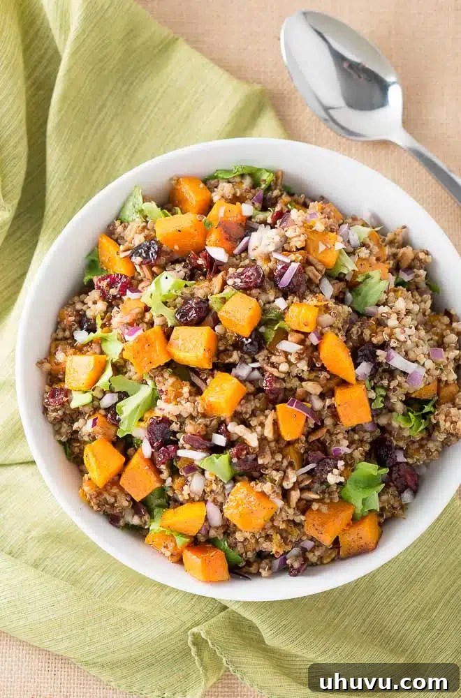 A vibrant bowl of Harvest Butternut Squash Quinoa Salad, garnished and ready to serve.