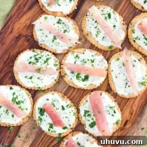 Ricotta Prosciutto Cracker Appetizer on a wooden platter