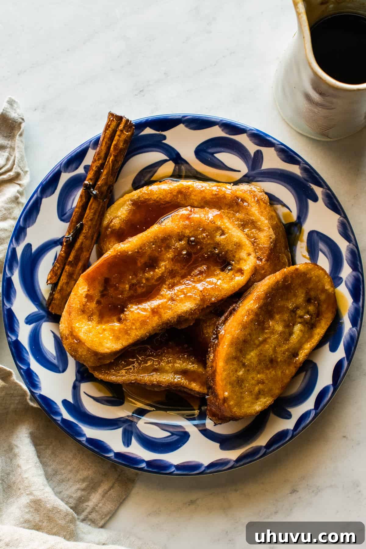 Torrejas Mexican French Toast 10 A stack of golden-brown Torrejas beautifully plated, with rich piloncillo syrup poured over them, ready to be enjoyed.