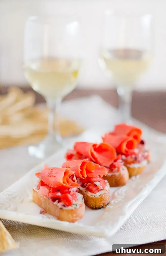 Beautifully arranged smoked salmon crostini with fresh herbs, ready to serve as an elegant appetizer.