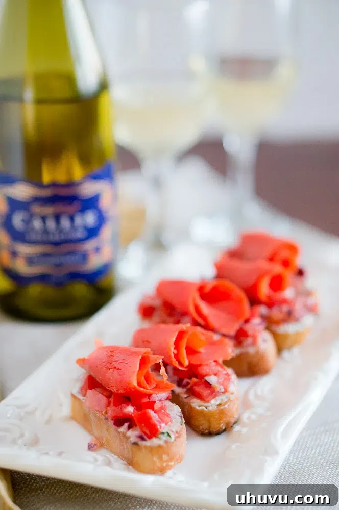 Finished smoked salmon crostini artfully arranged on a serving platter, garnished with fresh herbs.