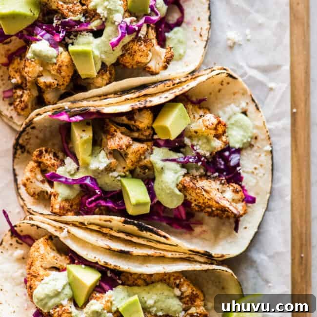Cauliflower Tacos topped with a cilantro lime cashew crema, ready to serve.