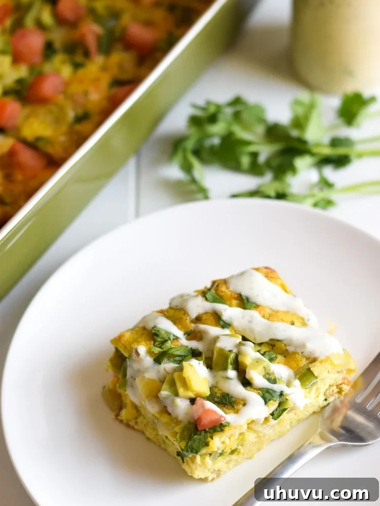 Zesty Salsa Verde Breakfast Frittata 8 A tempting serving of Salsa Verde Breakfast Frittata, glistening with the homemade yogurt sauce and garnished with fresh herbs, ready to be enjoyed as a gourmet breakfast or brunch.