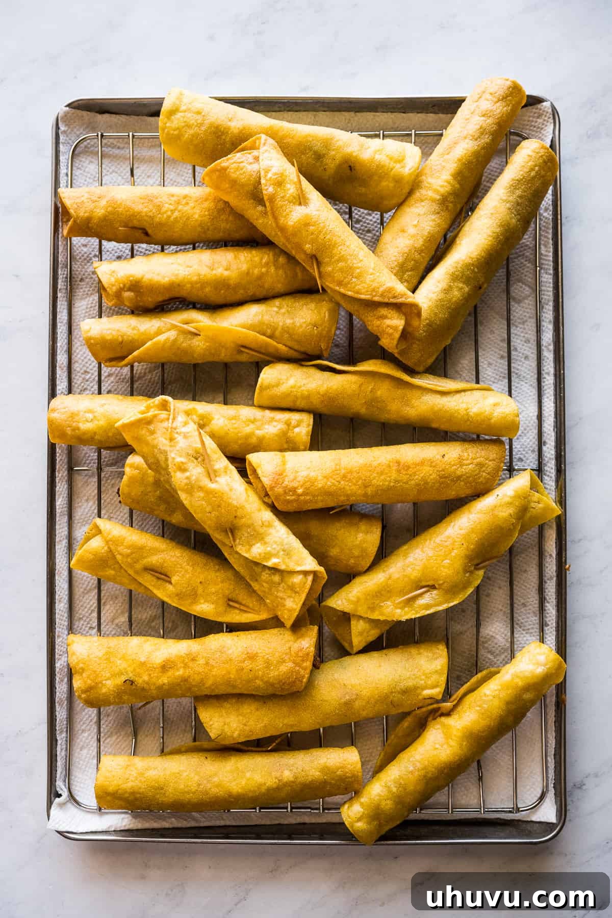 Crispy Rolled Tacos 12 Chicken flautas on a sheet pan.