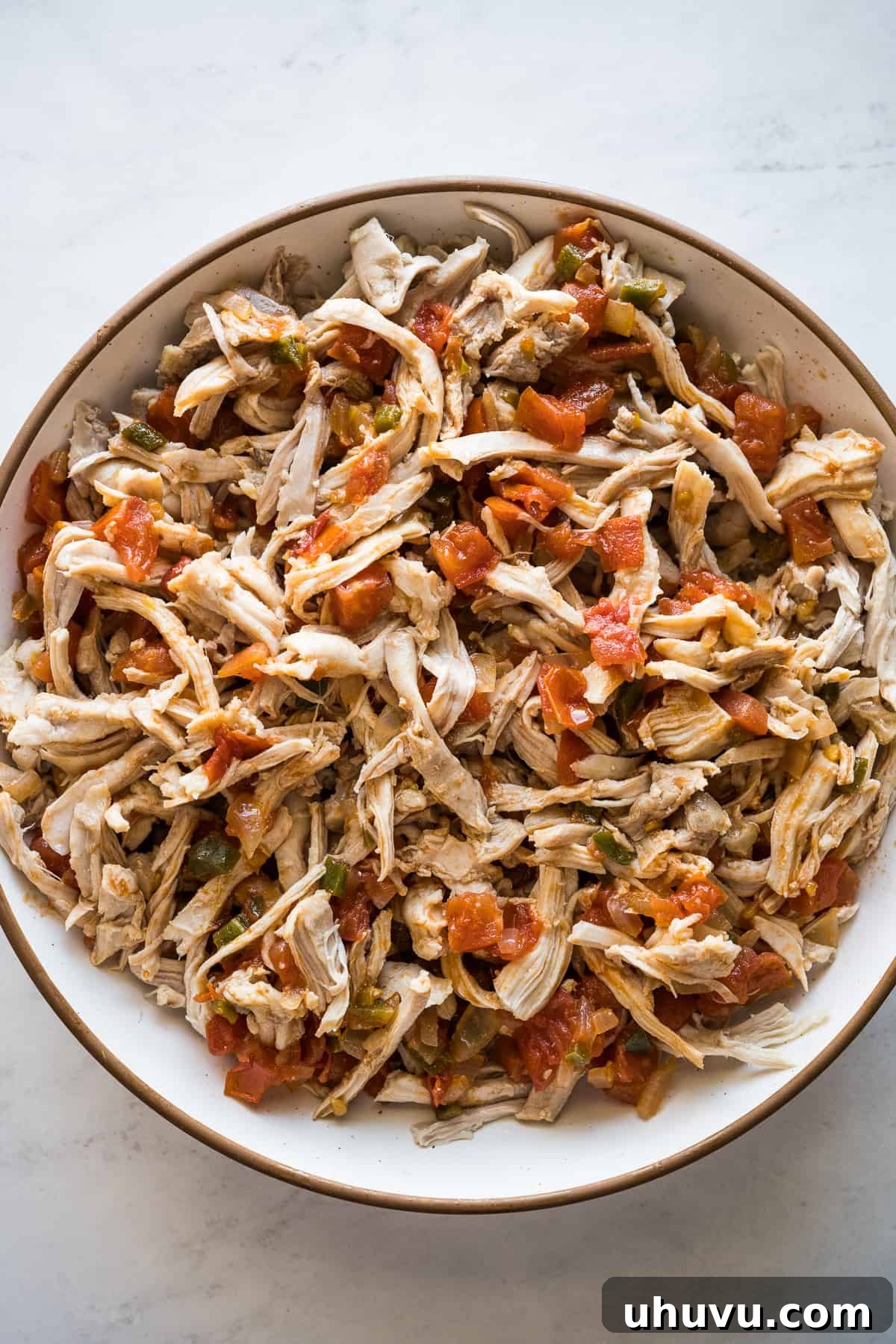 Crispy Rolled Tacos 7 Shredded chicken filling for flautas in a bowl.