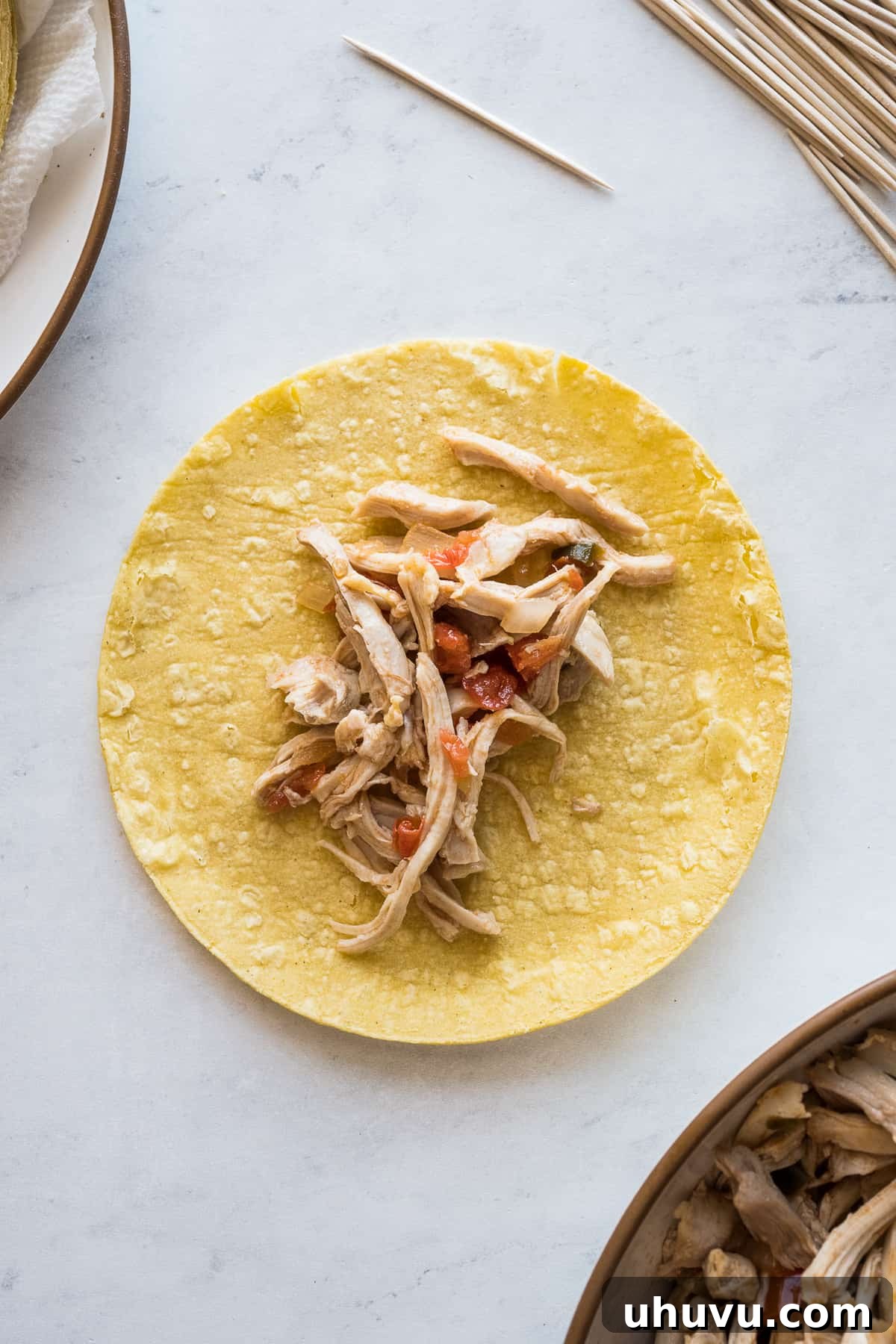 Crispy Rolled Tacos 9 Shredded chicken filling on a corn tortilla to make a flauta.