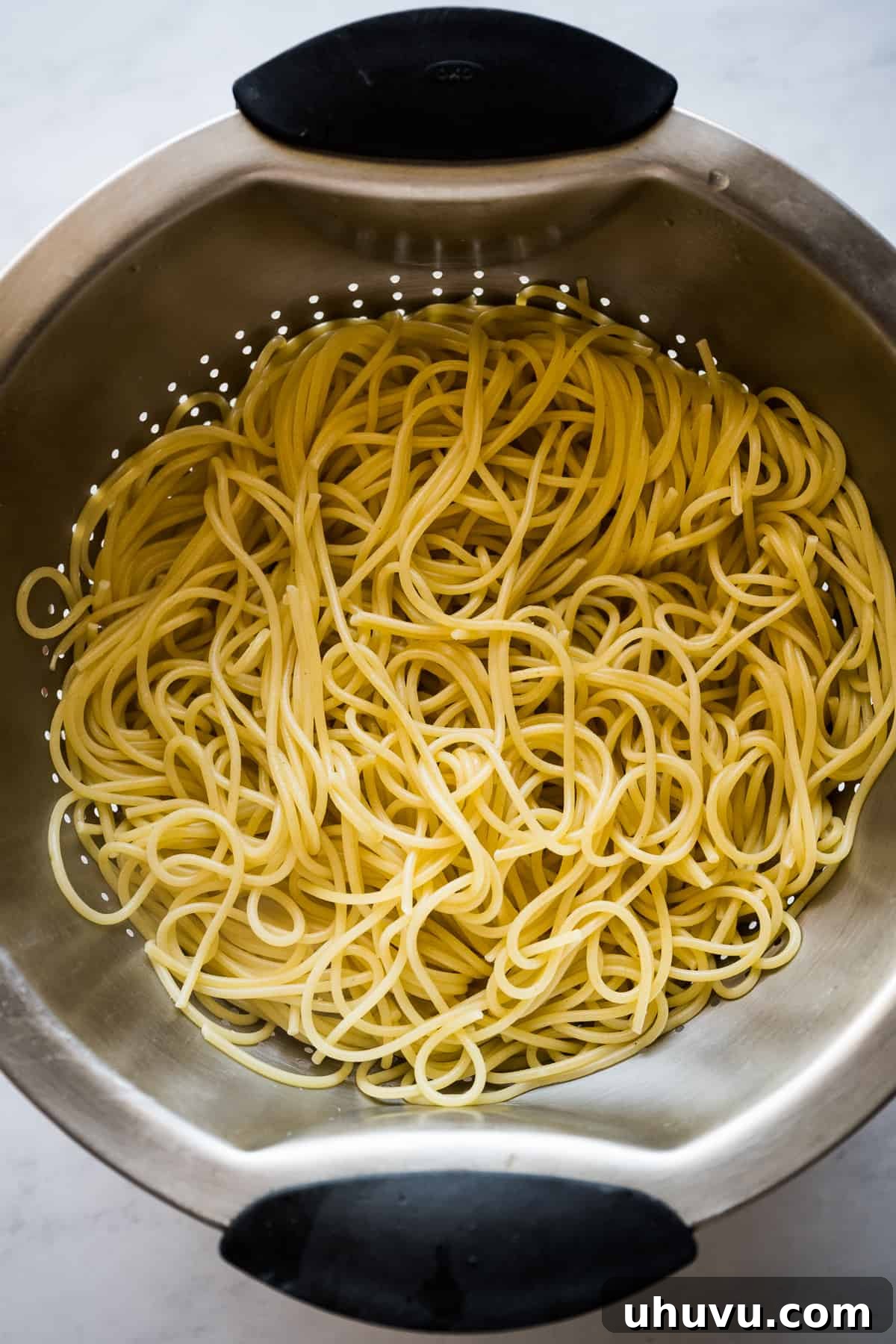 Zesty Green Spaghetti 4 Cooked spaghetti noodles in a colander, glistening and ready for sauce.