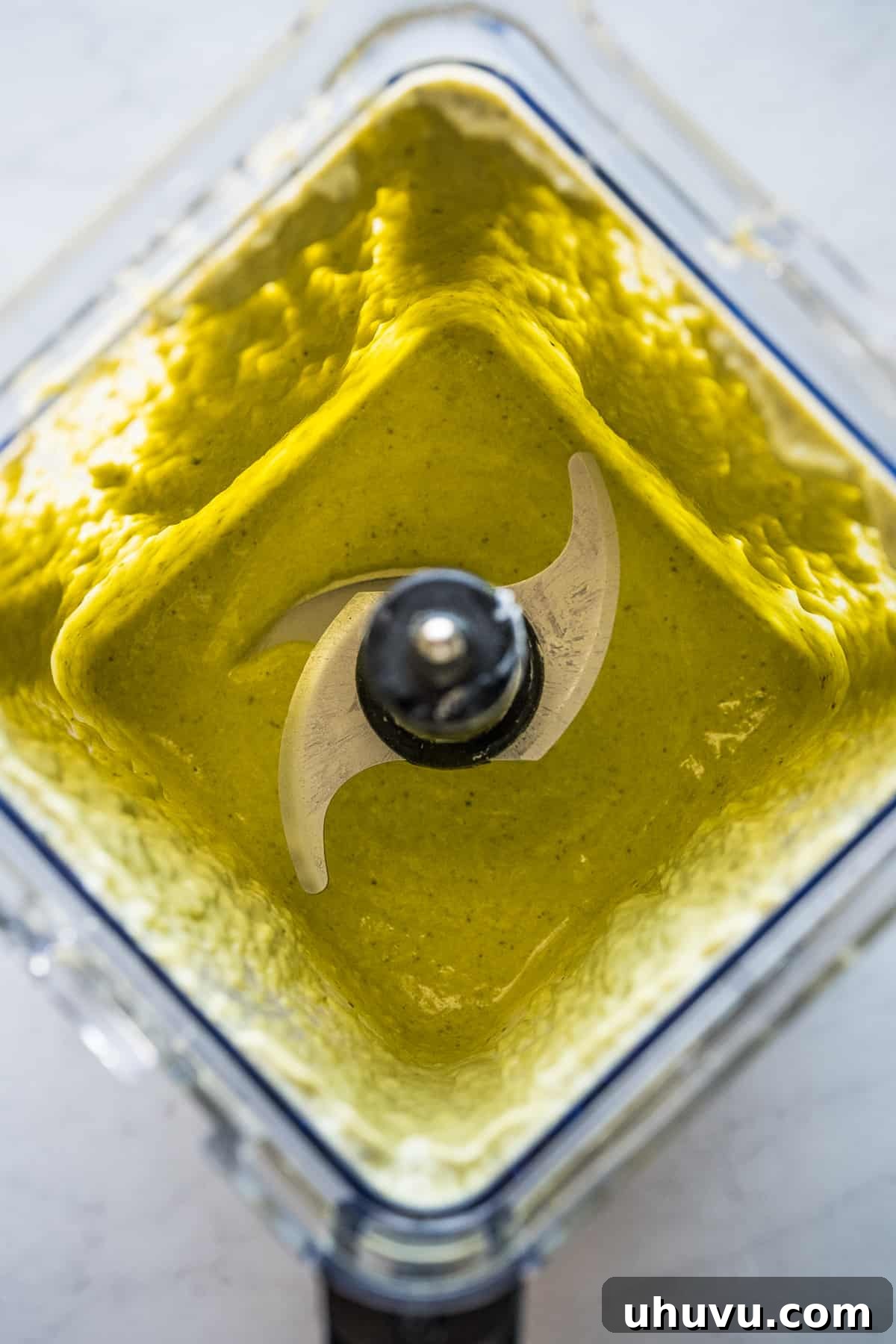 Zesty Green Spaghetti 9 A close-up of the smooth, vibrant green, blended creamy roasted poblano sauce in a blender jar.
