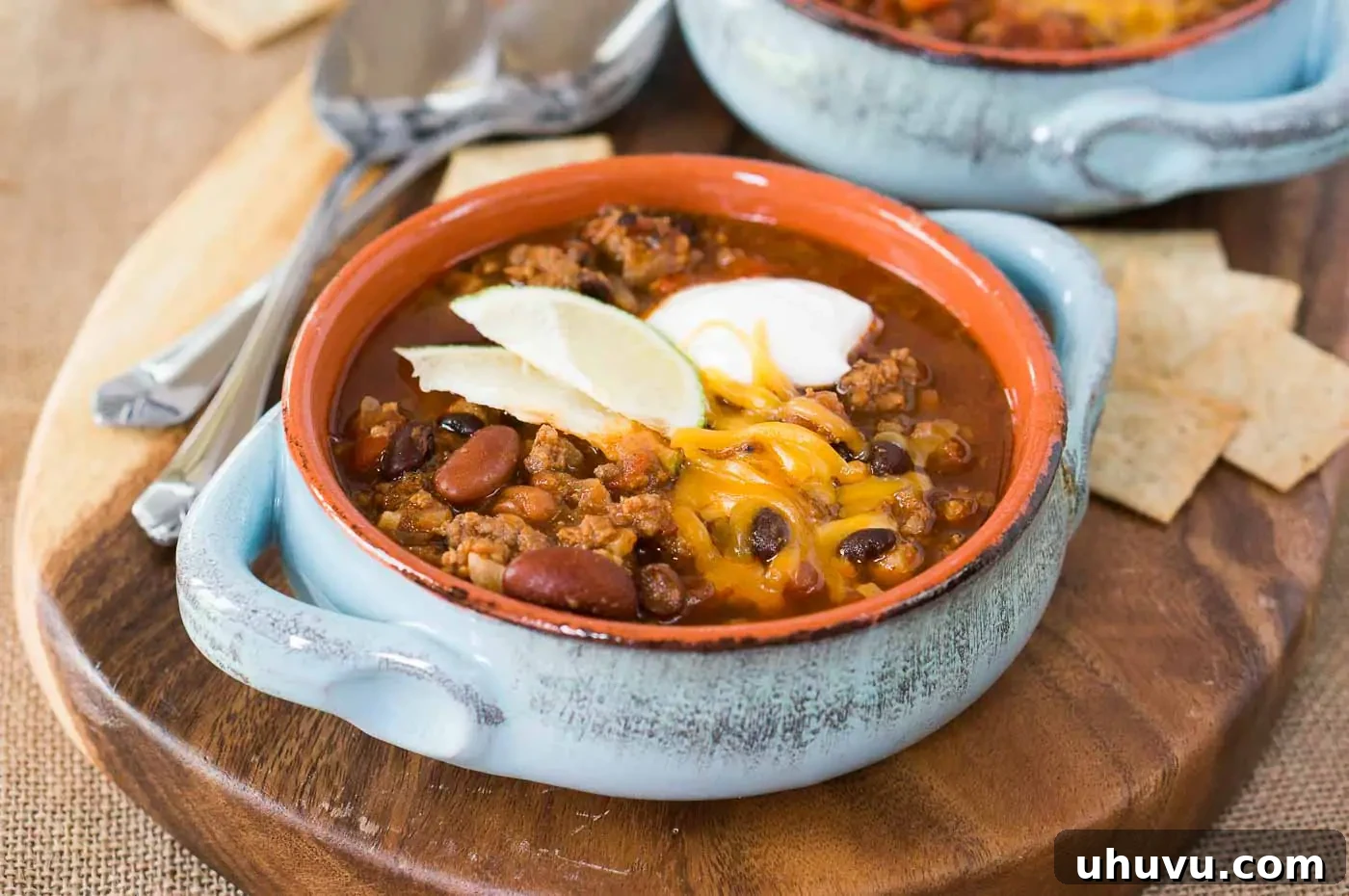 Hearty Instant Pot Chili 3 pressure cooker chili in a bowl with sour cream cheese and lime