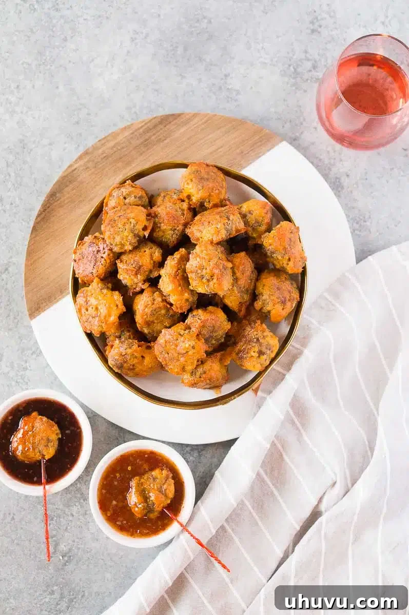 Delicious Grain-Free Keto Sausage Bites 3 Baked sausage ball recipe served with a vibrant dip, perfect for sharing