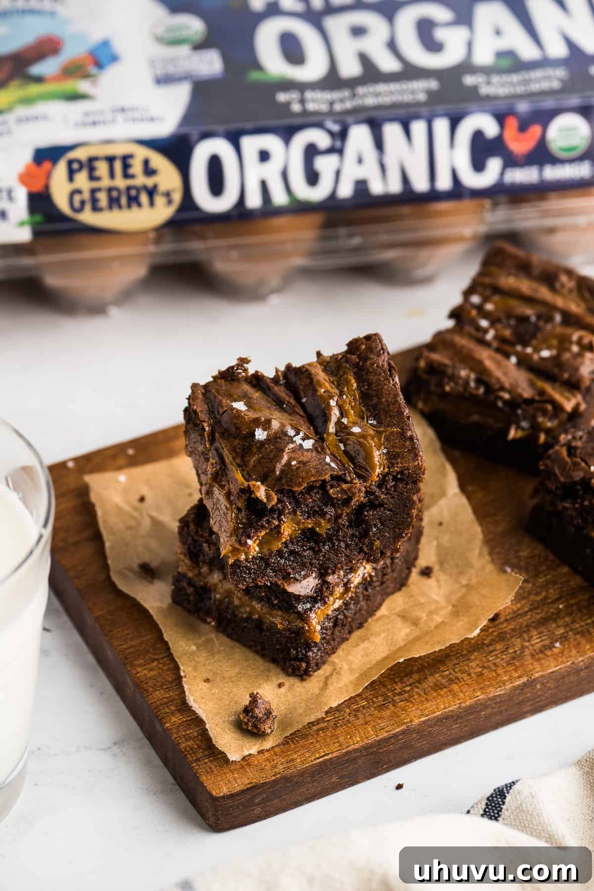 Dulce de Leche Brownies cut into squares on a table served with a glass of milk