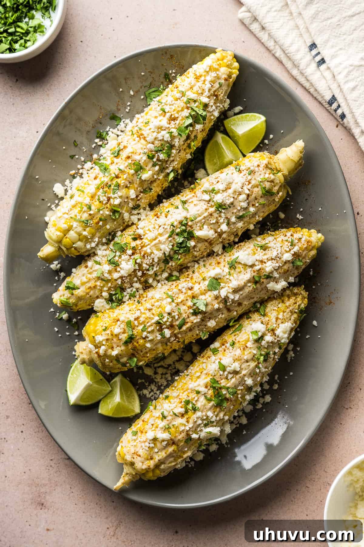 May Flavors Cook-Off 3 A second vibrant image of freshly prepared Mexican Street Corn (Elotes), showcasing the rich texture of the creamy sauce, crumbled Cotija cheese, and chili powder. It highlights the deliciousness and visual appeal of the challenge recipe.