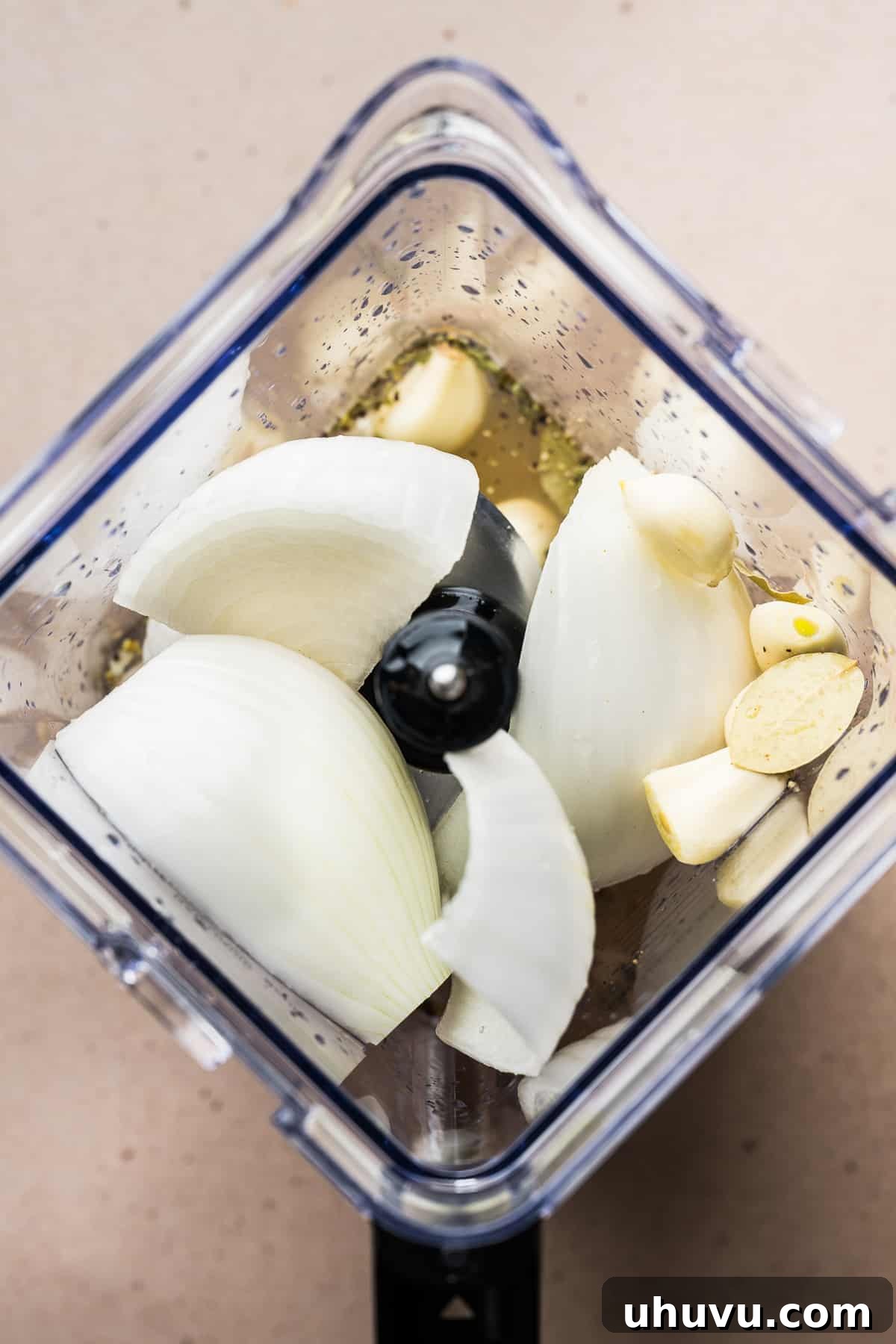 Onions, garlic, Mexican oregano, and bay leaves placed in a blender, ready to be processed for the Pozole Blanco broth.