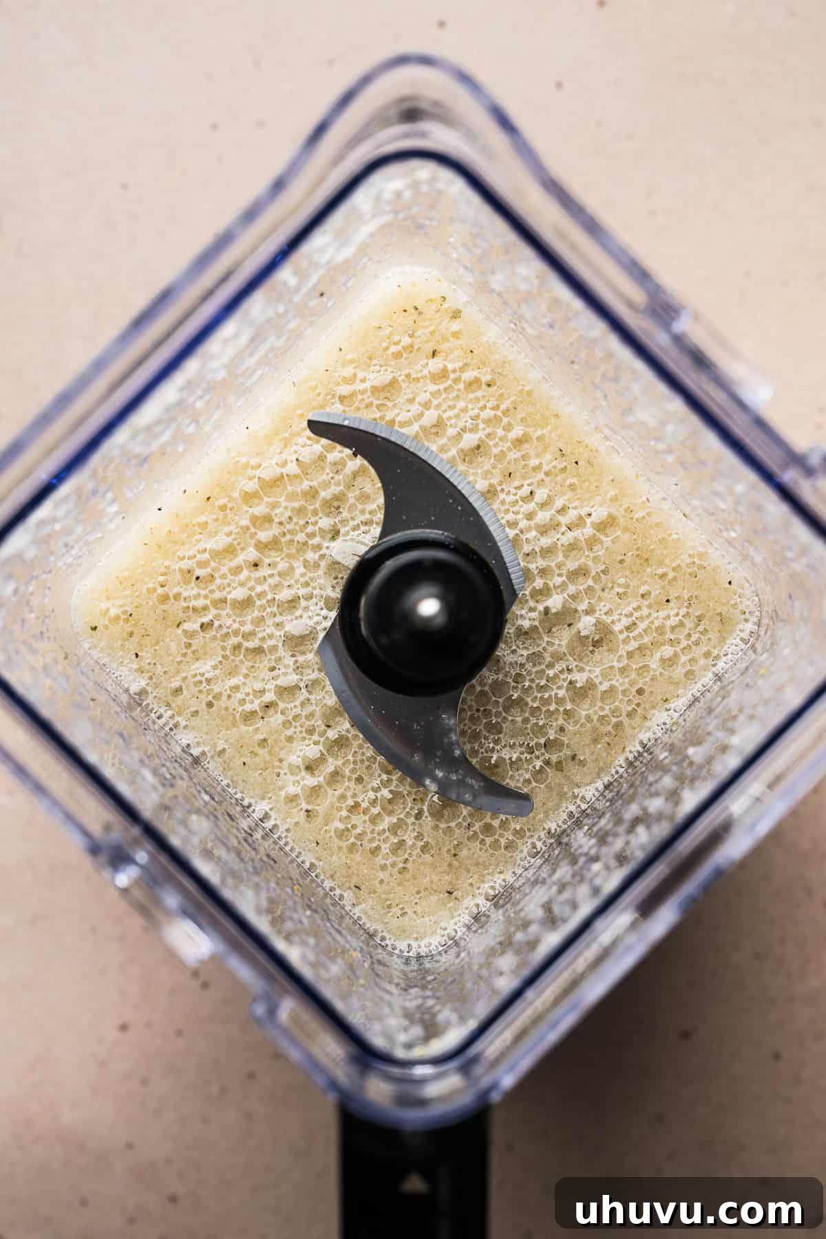 A close-up view of blended onions, garlic, and spices, transformed into a smooth, aromatic puree, ready to be added to the pot.