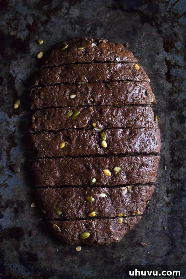 Crisp Cocoa Pepita Biscotti 2 Delicious Mexican Chocolate Pumpkin Seed Biscotti dipped in melted chocolate and sprinkled with sea salt, a perfect holiday dessert.