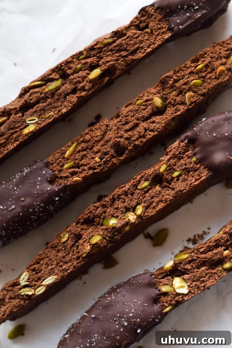 Crisp Cocoa Pepita Biscotti 7 A festive platter of Mexican Chocolate Pumpkin Seed Biscotti, some dipped in chocolate and sea salt, ready to be enjoyed during the holidays.