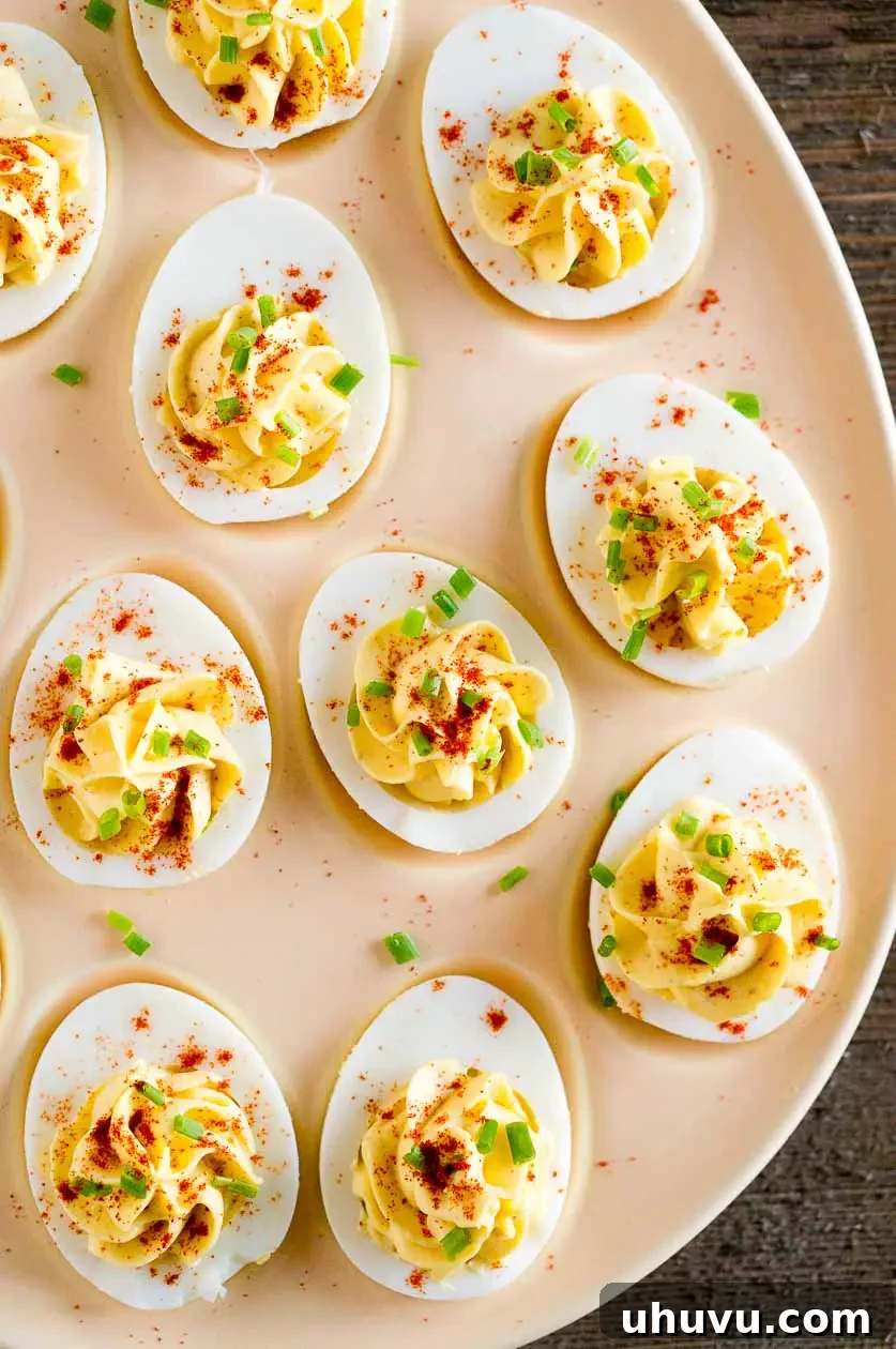 Close up of deviled eggs appetizer with paprika and chives