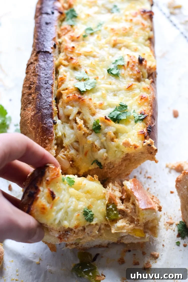 Golden-brown Chicken Fajita Stuffed French Bread, sliced and ready to serve, revealing a creamy, cheesy filling with colorful peppers and chicken.