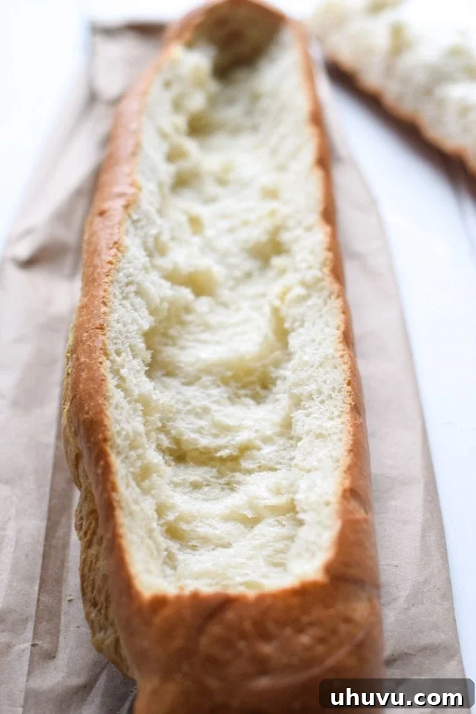 Close-up of the gooey, cheesy chicken fajita filling inside a hollowed-out French bread loaf before baking.