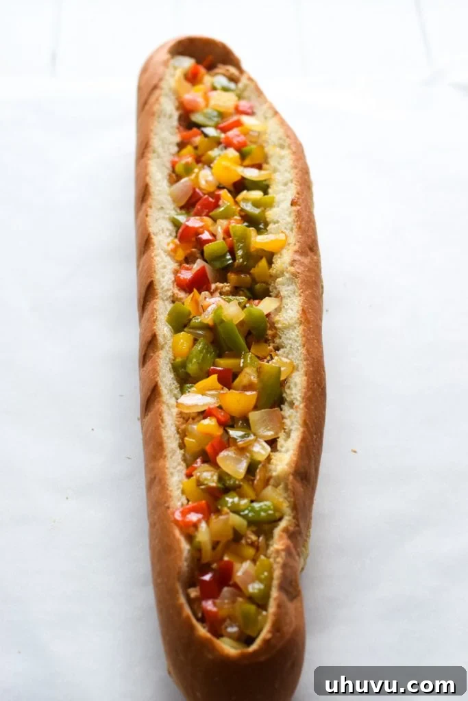 Preparing French bread by carefully cutting a rectangle into the top to create a pocket for the filling.