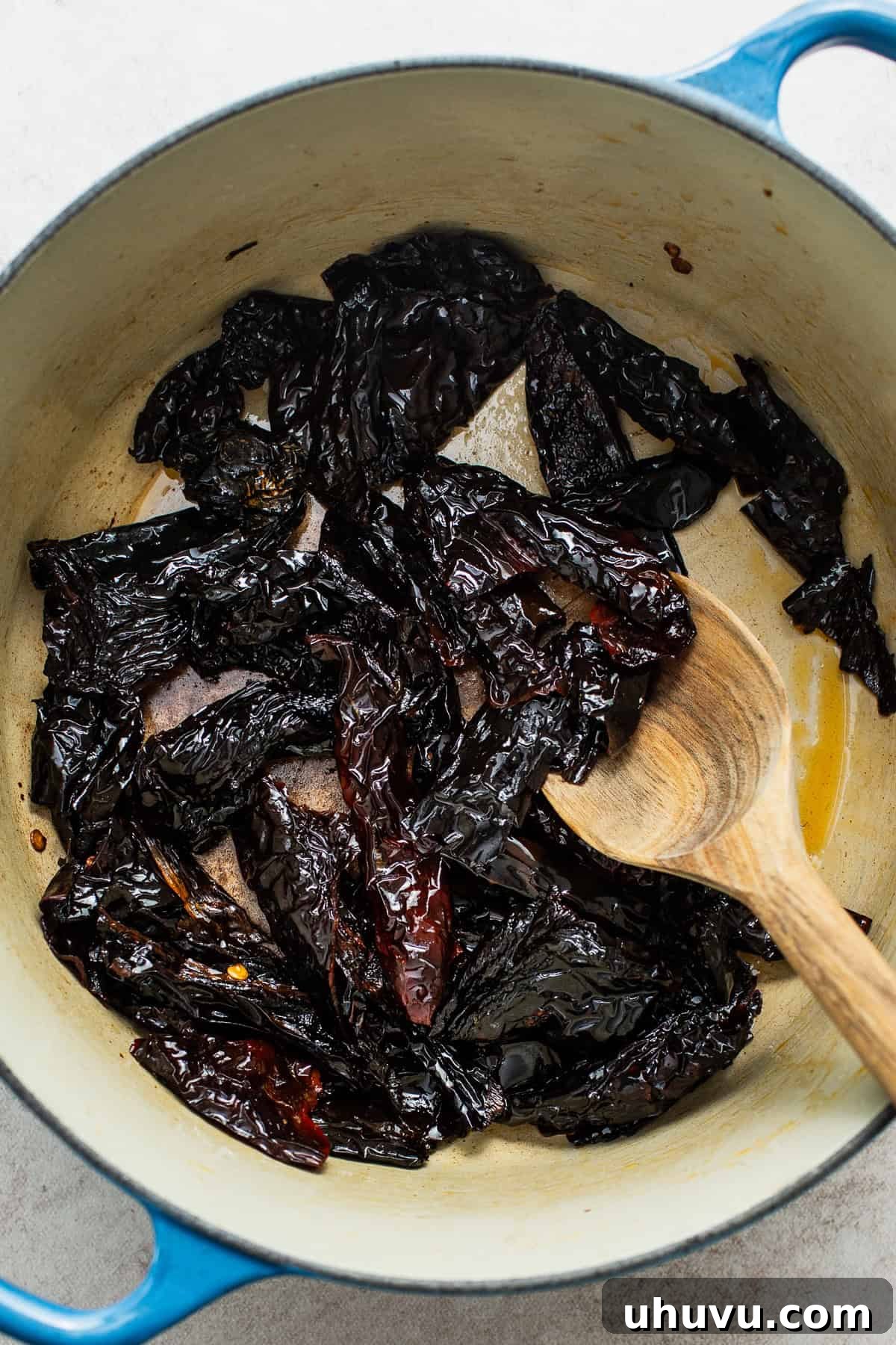 Classic Mexican Mole Poblano Sauce 5 Dried chiles being lightly fried in a pot with a small amount of oil until fragrant and slightly softened.