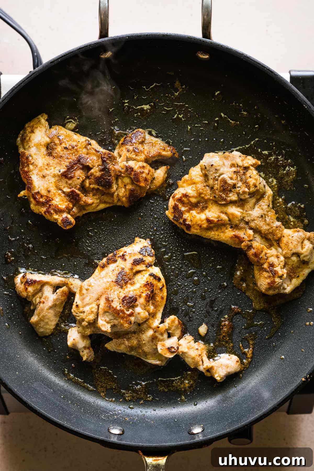 Your Secret to Perfectly Flavorful Chicken 5 Chicken being cooked in a skillet, sizzling and browning beautifully, indicating a delicious sear.