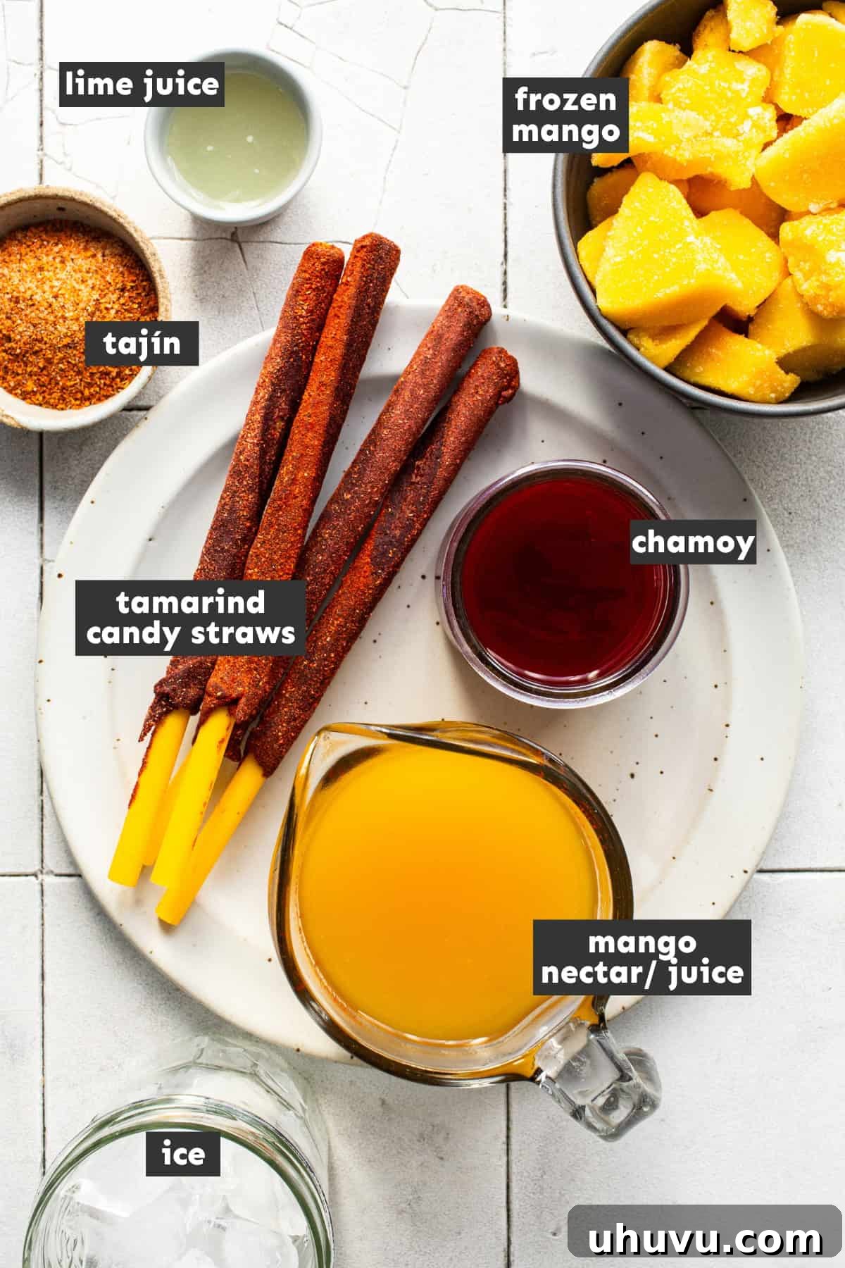 Mango Chili Thrill 3 All of the ingredients to make a mangonada are laid out on a table ready to use.