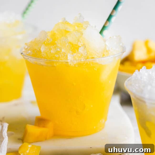 Raspados Mexicanos shaved ice in a cup with a straw made with a sweet mango syrup