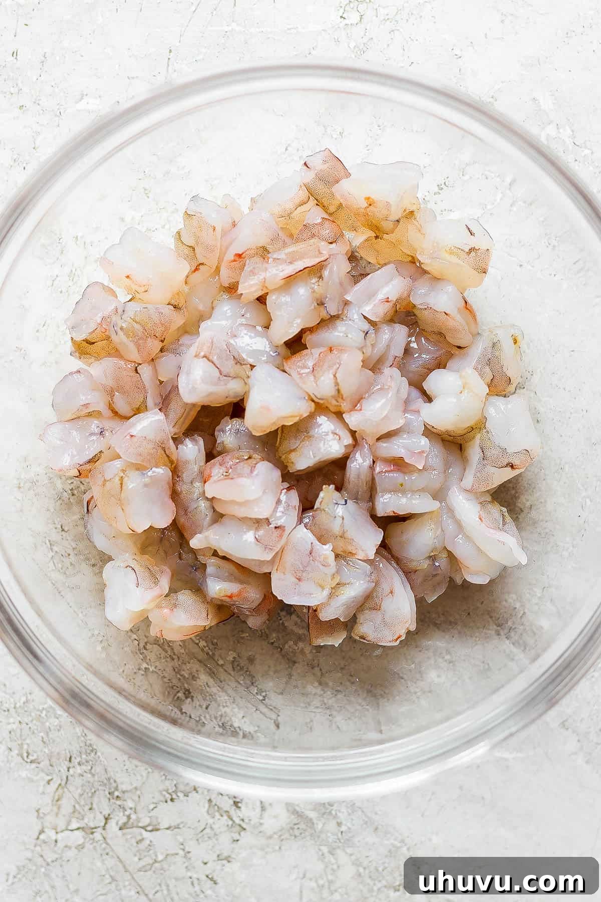 Ceviche The Zesty Seafood Sensation 4 Bite-sized raw shrimp in a bowl for ceviche.