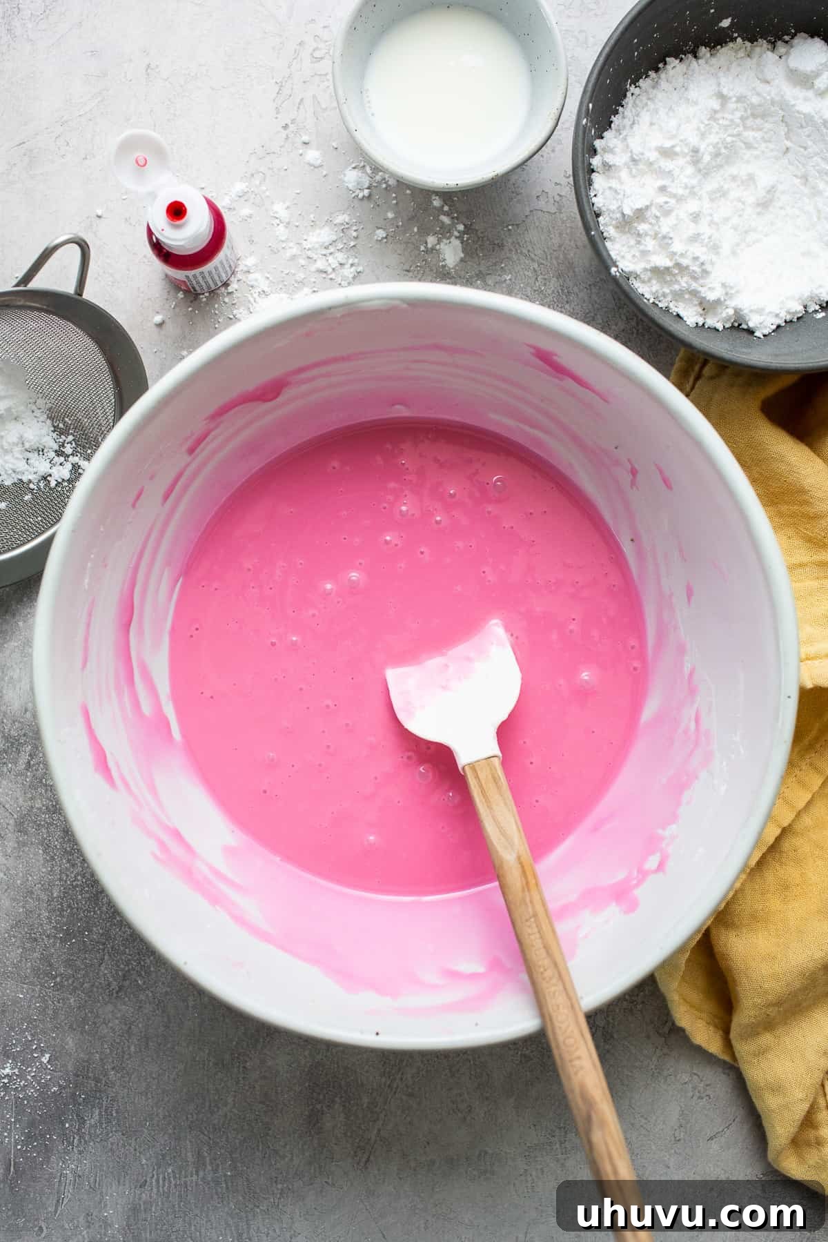 Mexico's Iconic Pink Cortadillo 6 Vibrant pink icing for Cortadillo in a bowl, ready to be spread onto the cake.