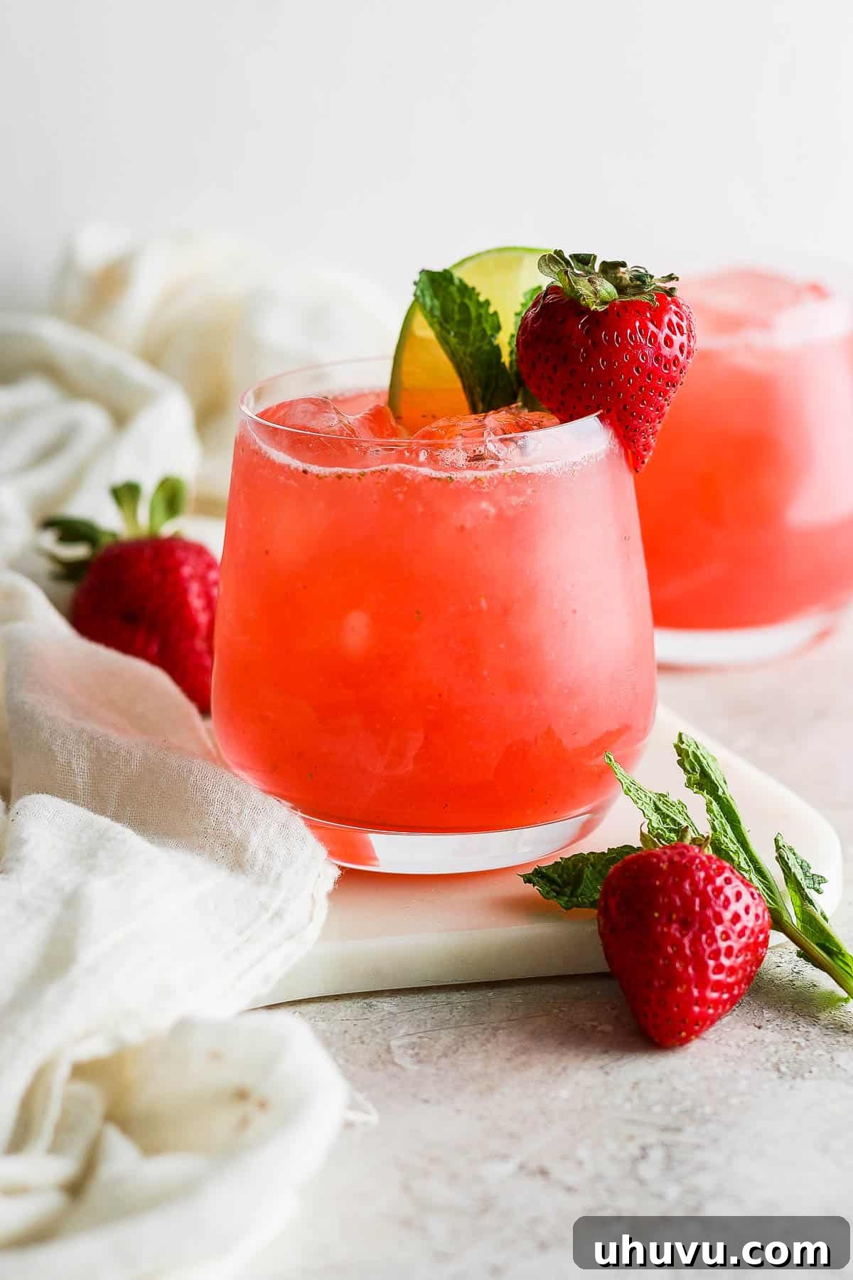 Refreshing Strawberry Sip 8 Agua de Fresa in a cup with ice ready to drink.
