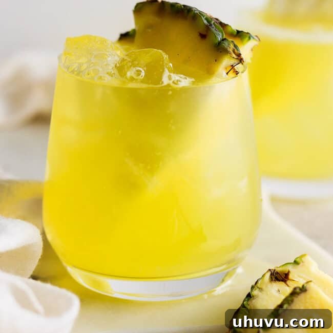 Tropical Pineapple Quencher 9 Agua de pina in a glass with ice.