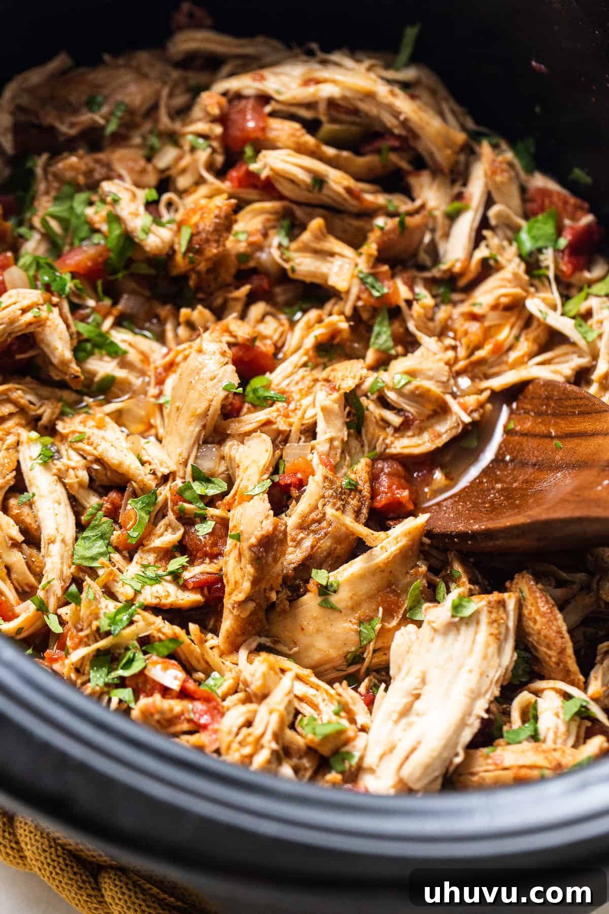 Crockpot chicken tacos in a slow cooker, featuring tender shredded chicken.
