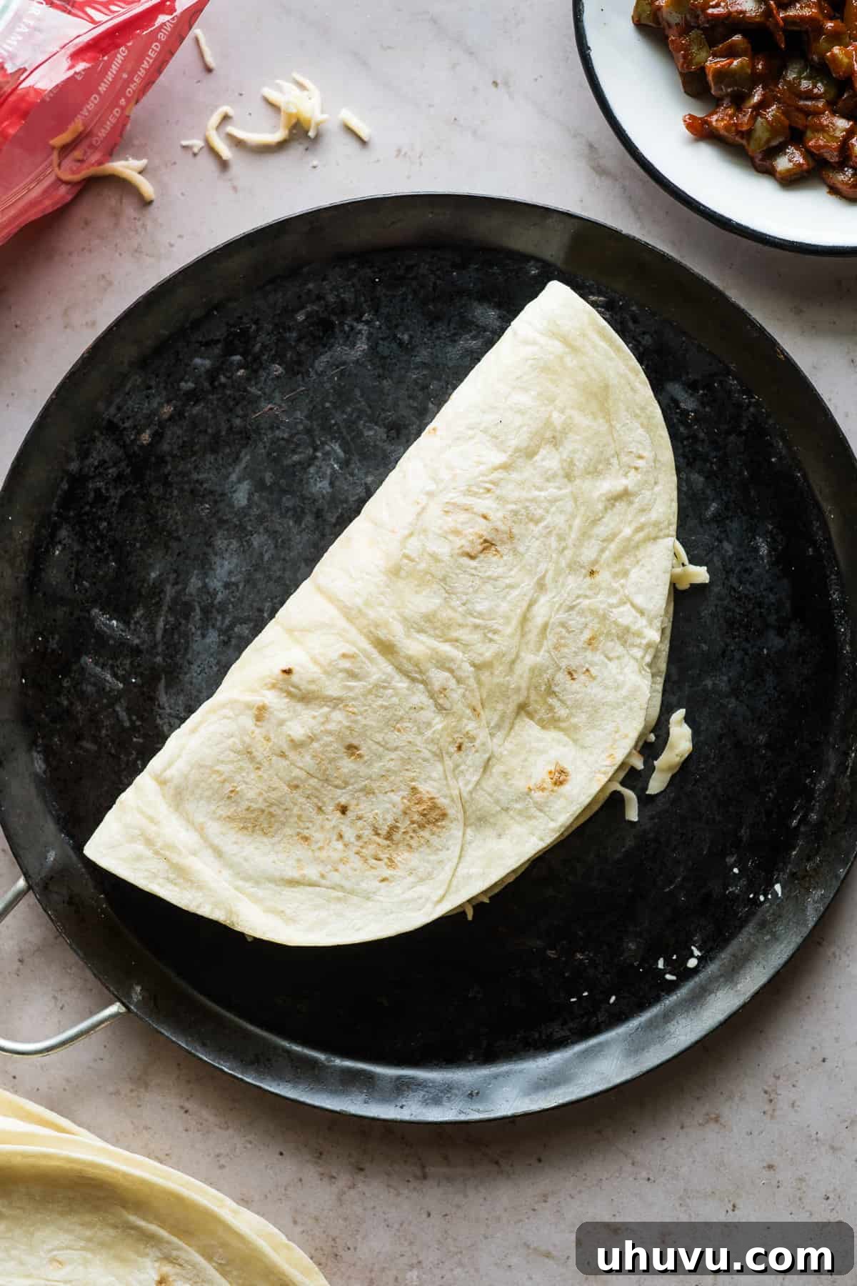Spicy Nopal Quesadillas 11 An uncooked quesadilla, perfectly folded and placed on a hot comal (griddle) to achieve golden-brown crispiness.