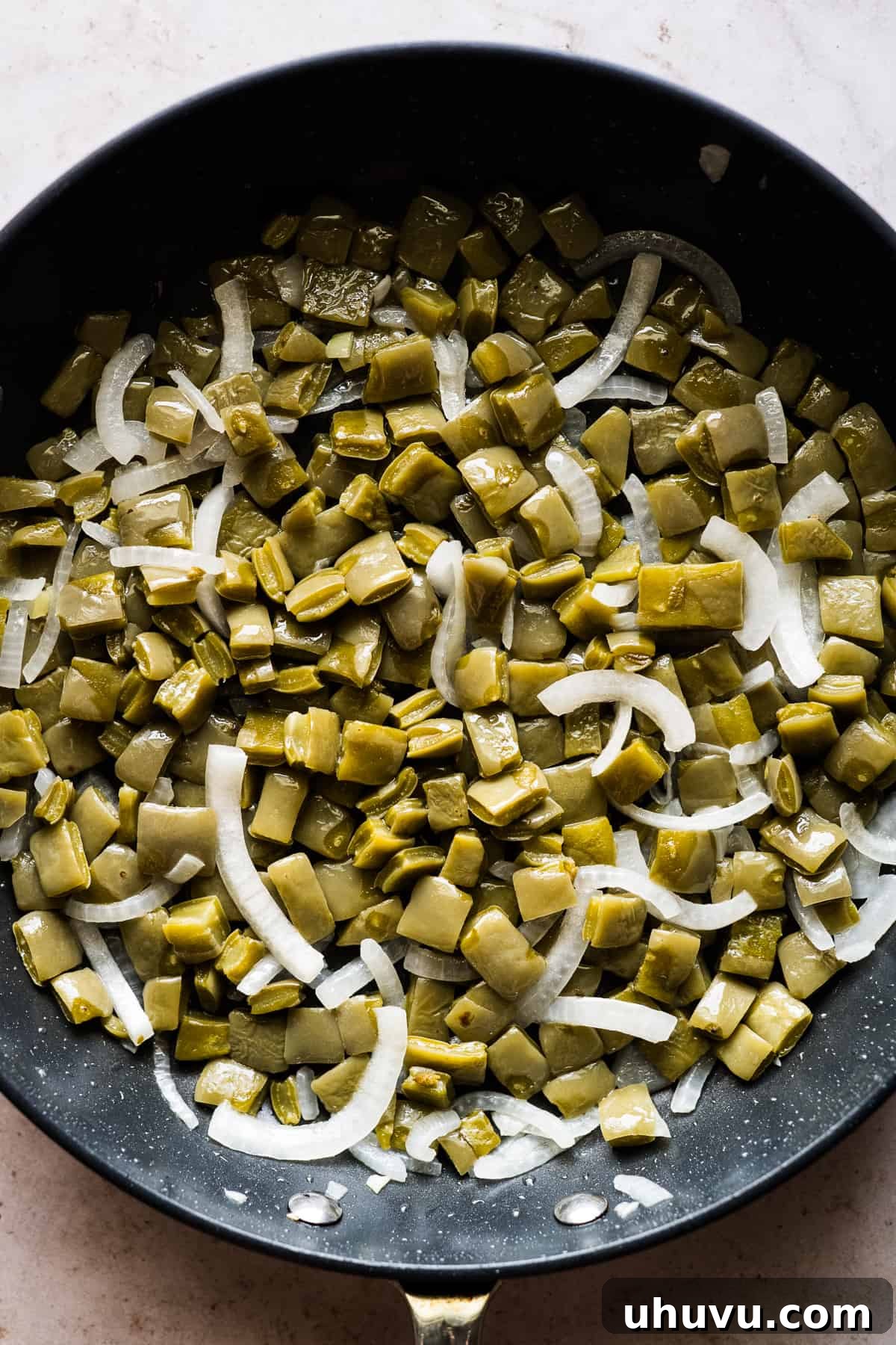 Spicy Nopal Quesadillas 8 Sautéed nopales and sliced onions in a skillet, building the base for the quesadilla filling.