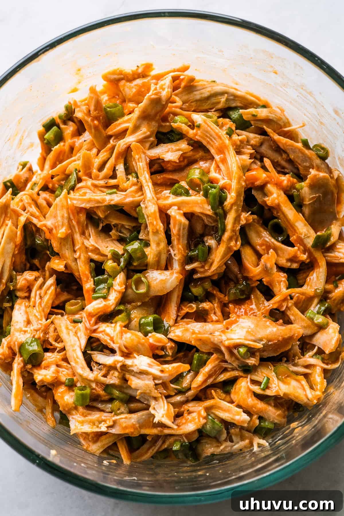 Zesty Buffalo Chicken Melts 5 Fully mixed buffalo chicken enchilada filling ingredients in a bowl, ready for assembly.