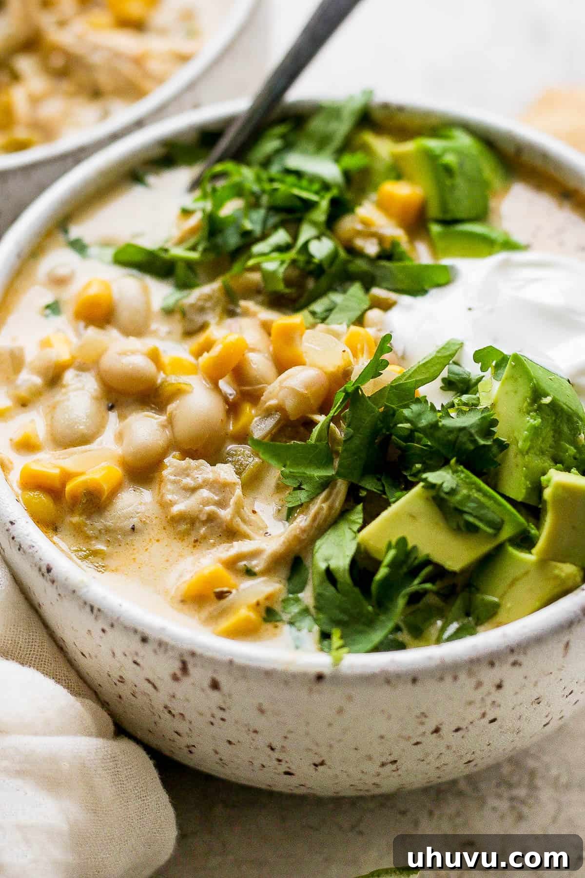 A delicious bowl of white chicken chili, beautifully garnished and ready to be enjoyed, showcasing its creamy texture and rich flavors.