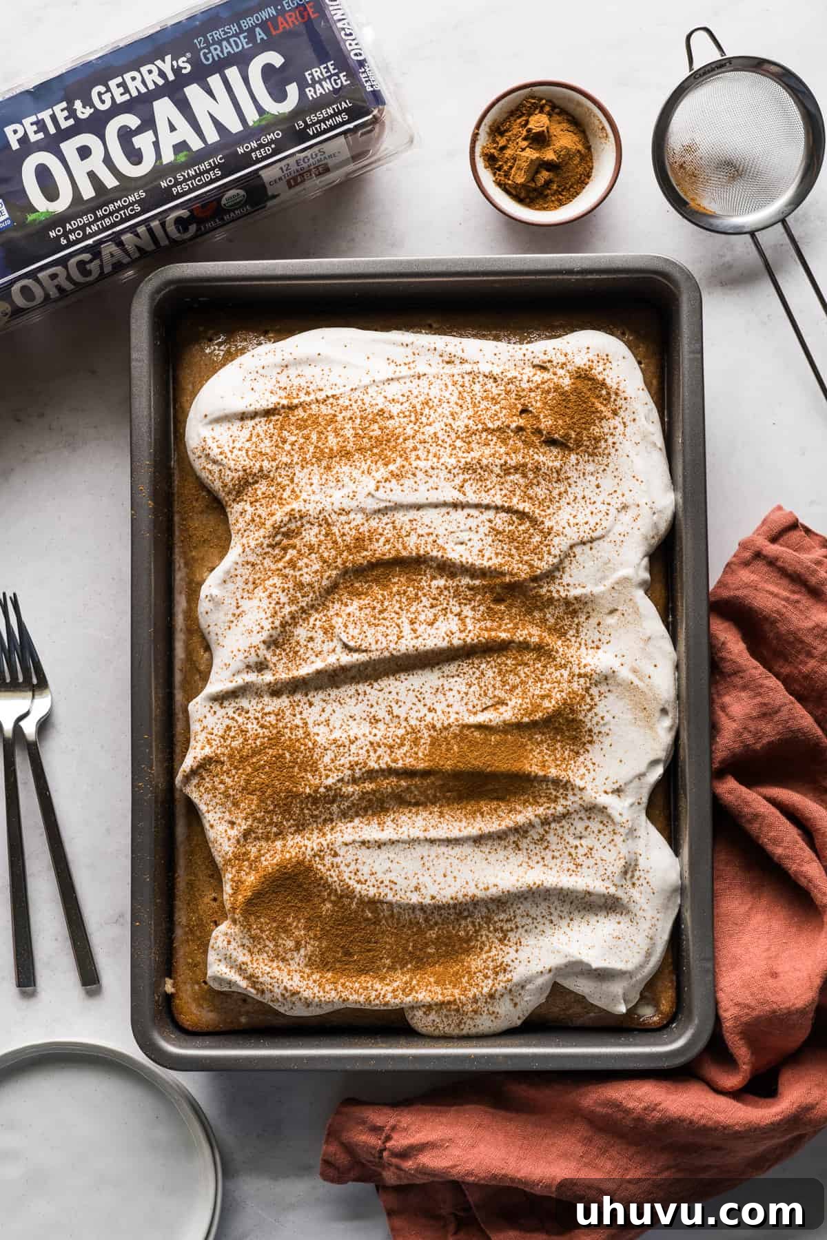 Spiced Apple Tres Leches Dream 7 A beautifully prepared apple tres leches cake generously topped with fluffy cinnamon whipped cream, ready for serving as a festive fall or winter dessert.