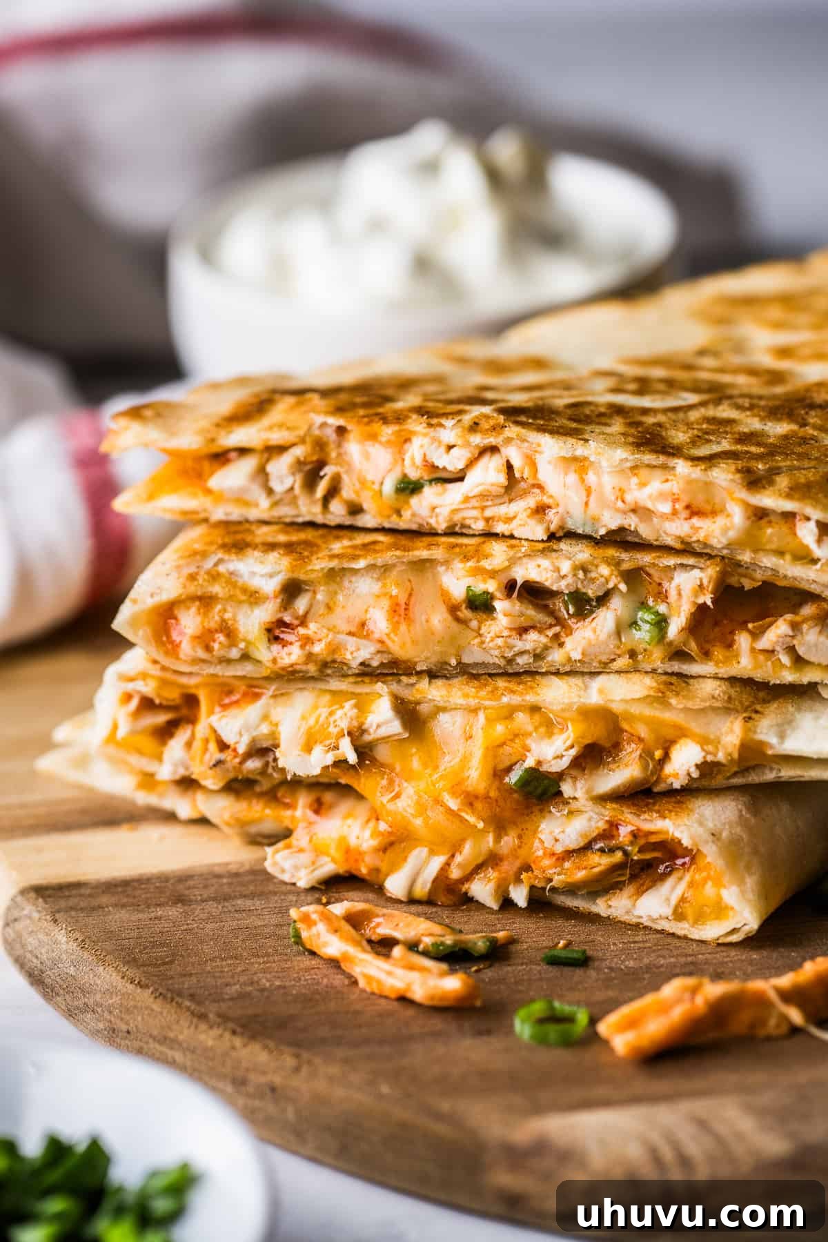Buffalo chicken quesadillas stacked on top of one another.