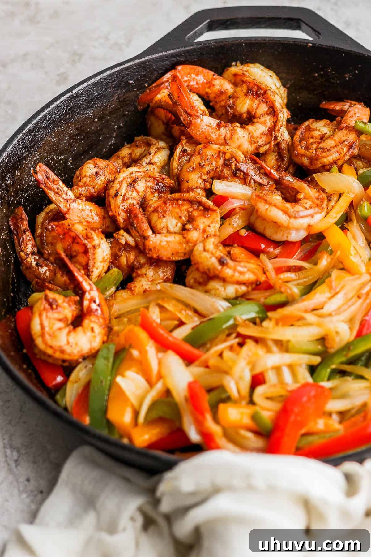 A skillet with shrimp fajitas.