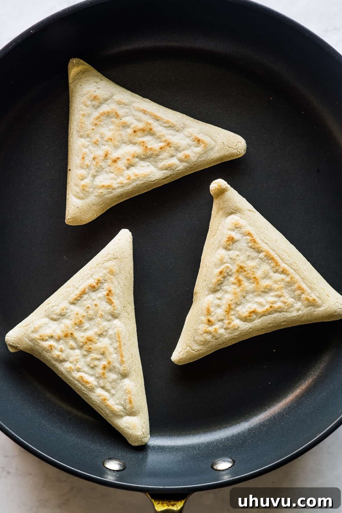 Mexican Masa Pockets 13 Tetelas cooking in a hot skillet.
